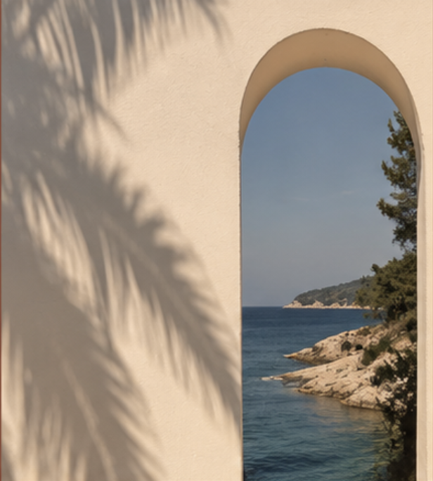 View through a sunlit stucco arch onto a calm blue sea, palm shadows on the wall