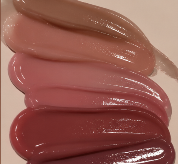 Five glossy product swatches smeared in a row, nude through rose to deep berry